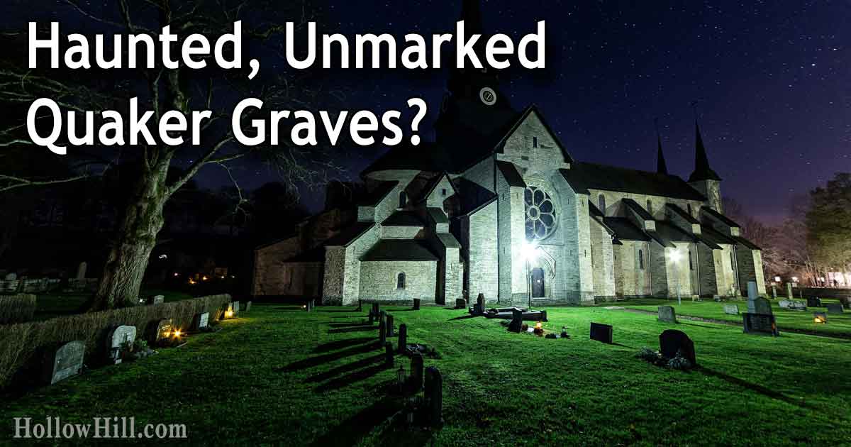 A church at night, with lights shining on a cemetery